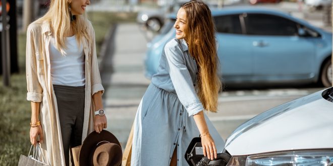 Woman charging electric car